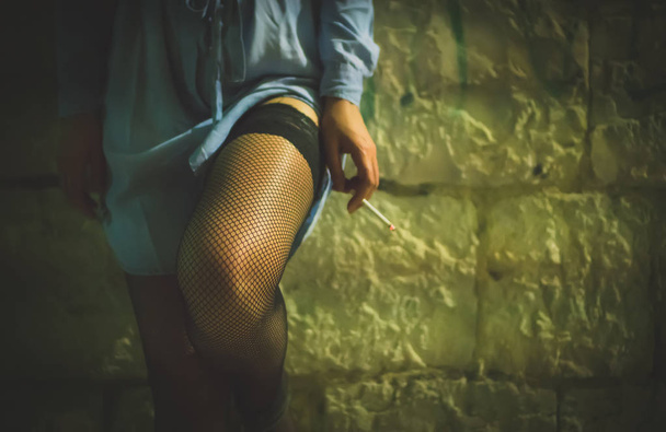 Prostitute with cigarette working on the night street. - Zdjęcie, obraz
