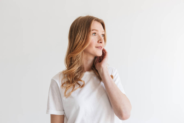 Image of amazing young cute redhead woman standing isolated over white wall background looking aside. - Valokuva, kuva
