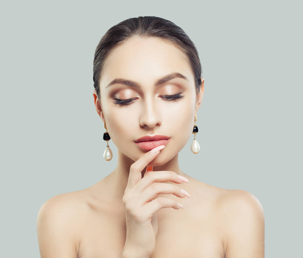 Thinking woman with perfect makeup and jewelry - Fotó, kép
