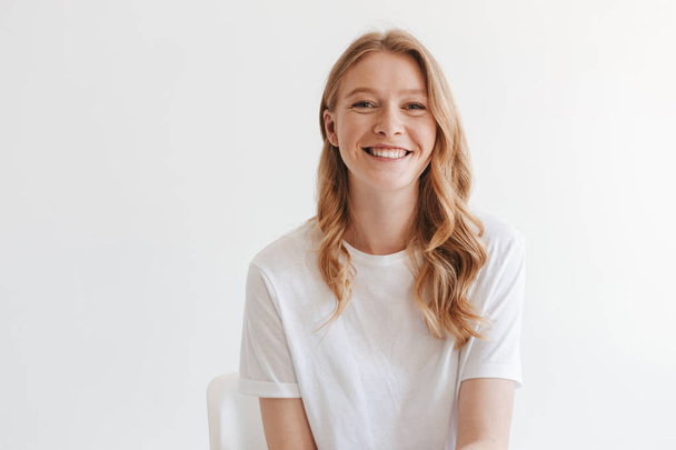 Image of young cute redhead woman isolated over white wall background looking camera. - 写真・画像