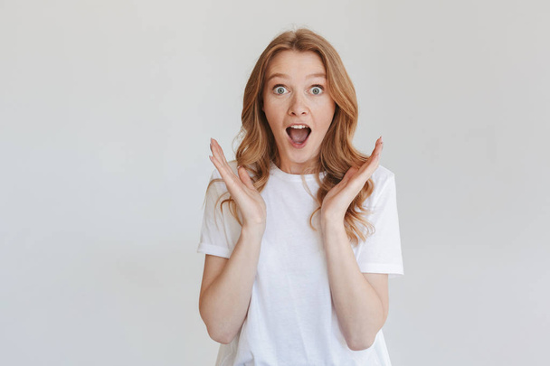 Image of young excited shocked redhead woman isolated over white wall background looking camera. - Photo, Image