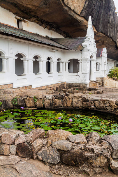 Exterior of Dambulla cave temple with a lotus flower pond, Sri Lanka - Fotoğraf, Görsel
