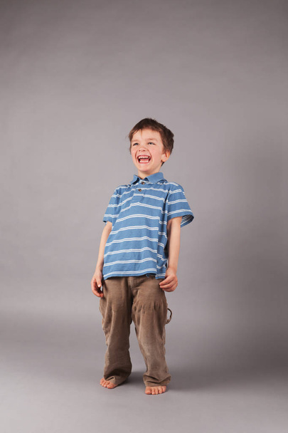 Portrait of little boy on gray backgraund, indoor - Photo, image