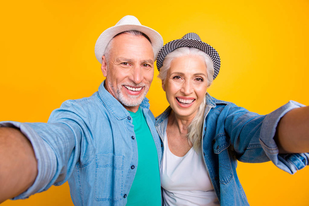 Tourist tourism travel healthy dental video-call lifestyle concept. Close up photo portrait of cheerful joyful beautiful careless excited old guy and grandma making selfie isolated bright background - Fotó, kép