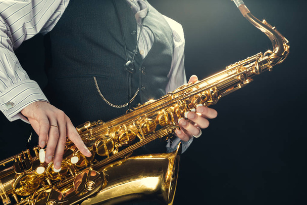 Young man playing the Saxophone - Fotó, kép