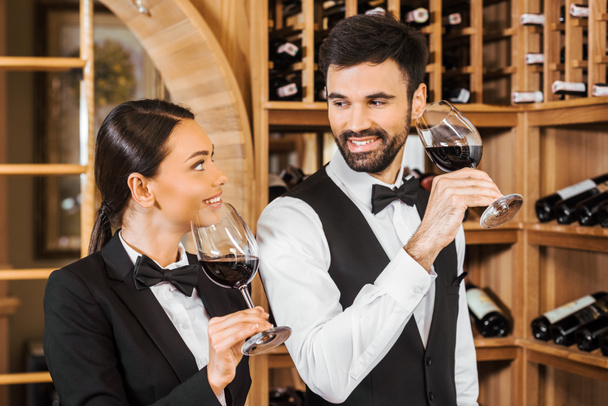 couple of happy wine stewards making degustation together and chatting at wine store - 写真・画像