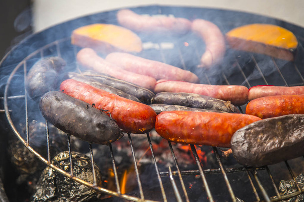 BBQ with sausages, pumpkin pieces and potatoes - Photo, Image