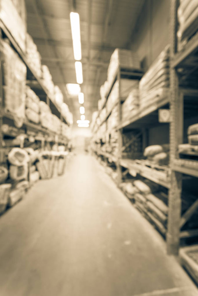Vintage blurred a large hardware store. Defocused interior of home improvement retailer with racks, aisles of building material insulation from floor to ceiling. Construction wholesale concept - Photo, Image