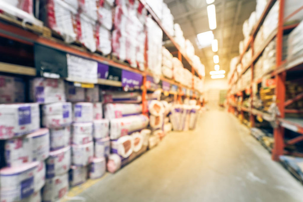 Vintage blurred a large hardware store. Defocused interior of home improvement retailer with racks, aisles of building material insulation from floor to ceiling. Construction wholesale concept - Photo, image