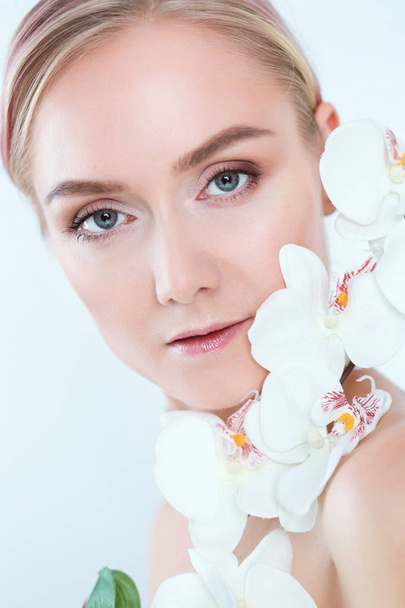 Young beauty woman with flower near face. - Photo, Image
