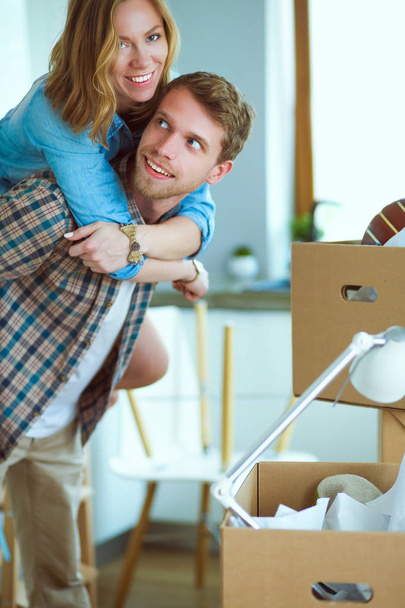 Couple unpacking cardboard boxes in their new home. Young couple. - Valokuva, kuva