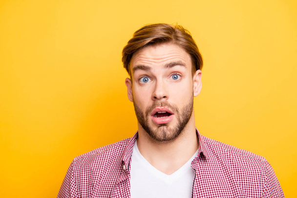 Close up portrait of handsome excited cheerful joyful attractive amazed funny with big eyes entrepreneur wearing red checkered shirt and white t-shirt isolated on bright yellow background copyspace - Φωτογραφία, εικόνα