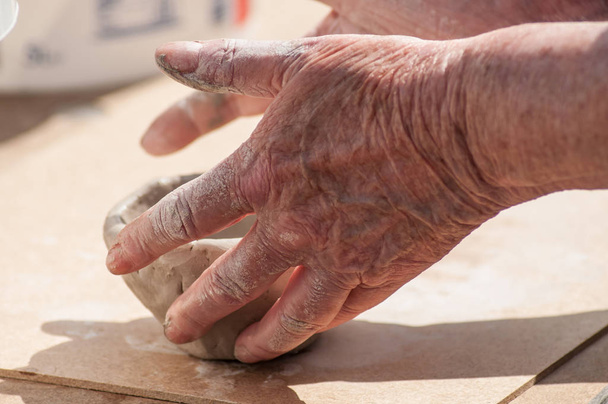 closeup of hands of old woman making clay pottery bowl in outdoor  - Foto, immagini