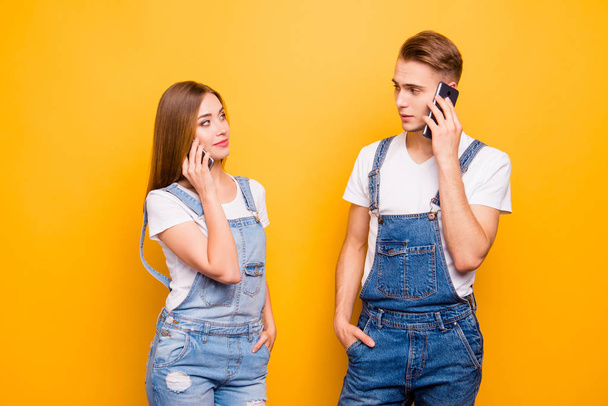 He and she jealous people concept. Close up photo portrait of handsome gentleman pretty lady holding cellular near ear listening to subscriber operator call center isolated bright background - Photo, image