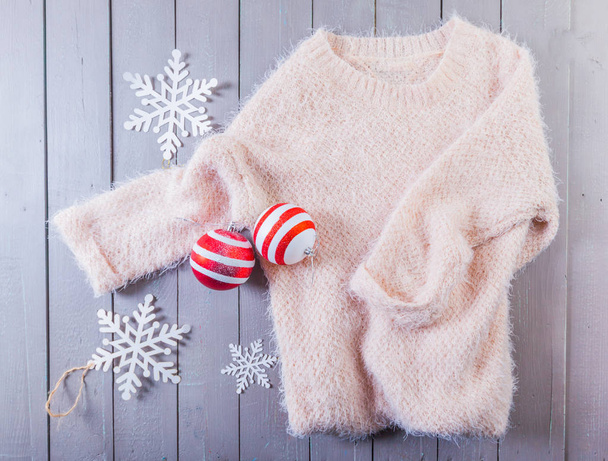sweater and Christmas toys  on  wooden background  - Foto, immagini