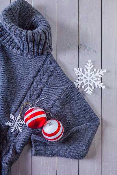 sweater and Christmas toys  on  wooden background  - Fotoğraf, Görsel