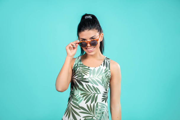 cloe up portrait of joyful model wearing sunglasses in summer ourfit - Photo, Image