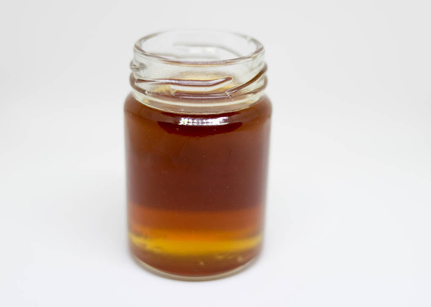 honey bee in jar glass on white background - Foto, Imagem