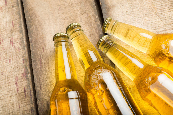 Beer bottles on wooden background - Foto, immagini