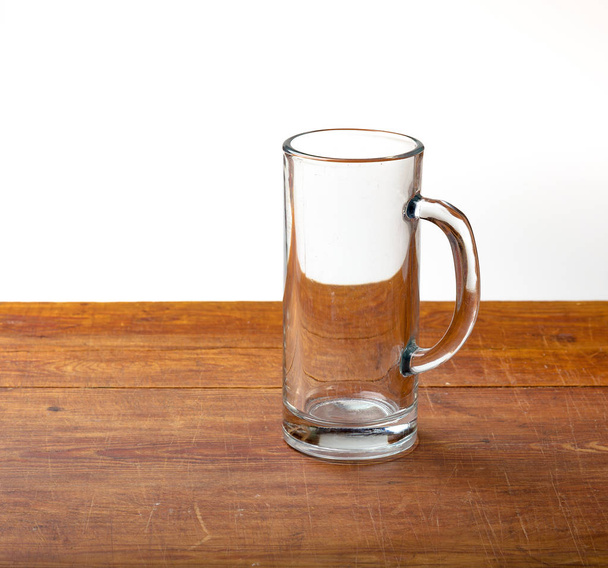 large empty pint of beer on old wooden table - Fotografie, Obrázek