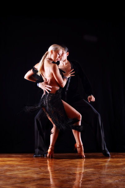 Dancers in ballroom against black - 写真・画像