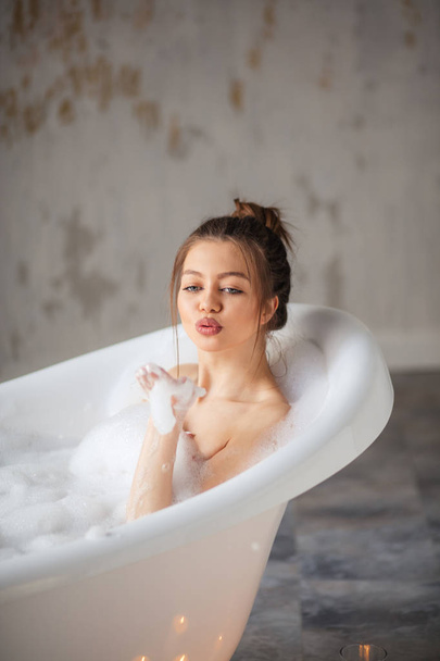 pretty woman blowing bubbles in hands - Foto, immagini