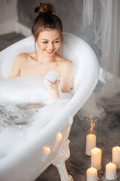 pleasant girl enjoying bubble bath - Foto, afbeelding