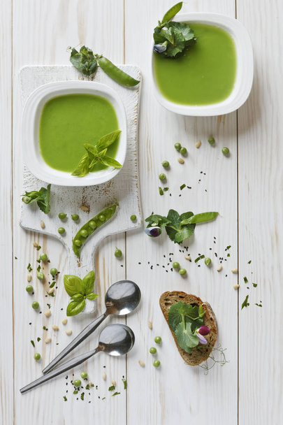 Homemade fresh green pea cream soup with spices, pine nuts and toast - Photo, image