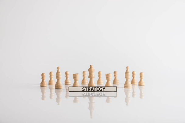 Wooden chess pieces strategy concept on a white background with copy space. - Photo, Image