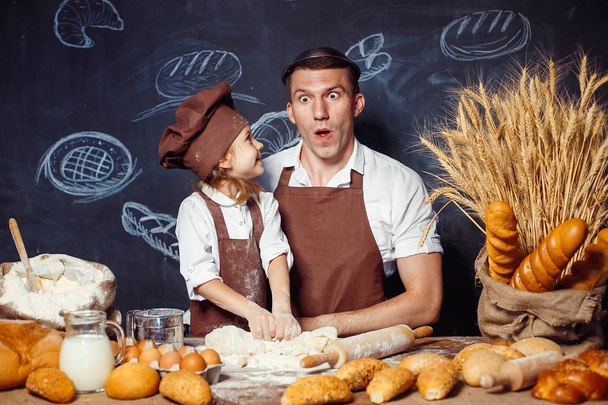 Playful man with daughter making bread - Photo, Image