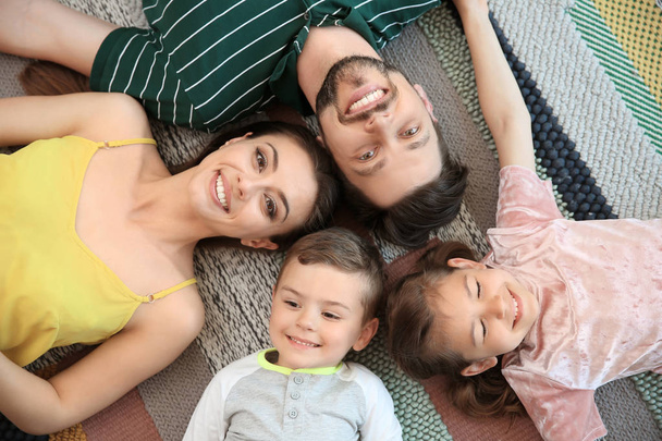 Portrait of happy family with children indoors, top view - Foto, Bild