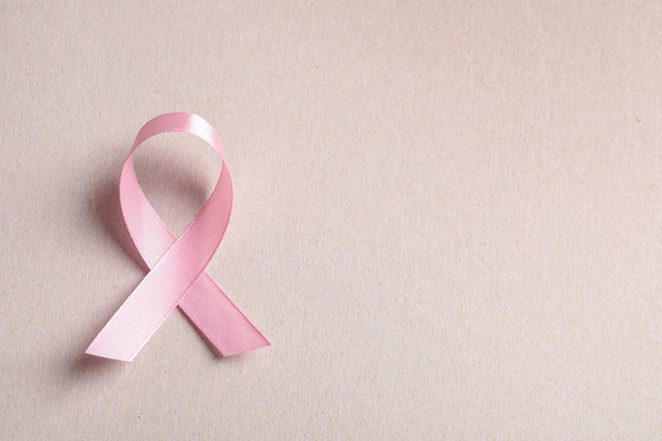 Pink ribbon on color background, top view. Cancer awareness - Foto, Imagem