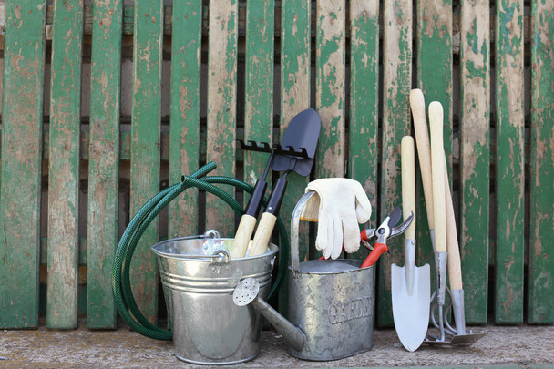Set of gardening tools near wooden fence - Valokuva, kuva