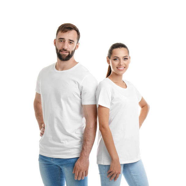 Young couple in t-shirts on white background. Mockup for design - Photo, image