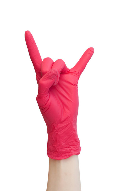 Rock sign made of red medical gloves. Fingers showing rock n roll symbol. Healthy, vitamins, vaccination, afraid of injections, medical store, pharmacy, recovery, proper nutrition concept - Foto, afbeelding