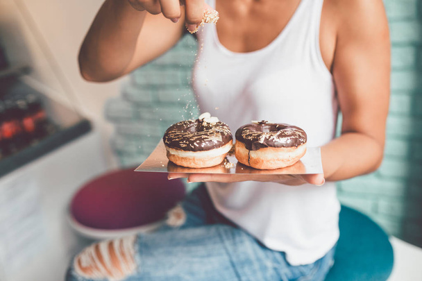 woman enjoying in delicious glazed and decorated donuts. Selective focus - Foto, imagen