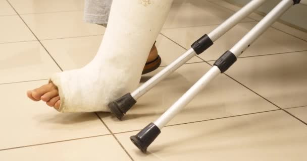 Patient wartet mit Beinbruch und Krücken im Krankenhauszimmer  - Filmmaterial, Video
