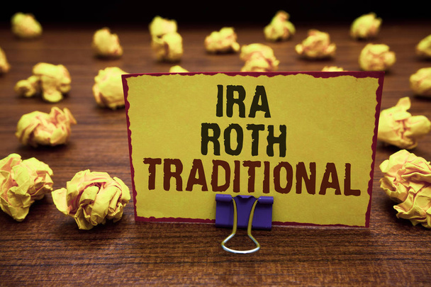 Handwriting text writing Ira Roth Traditional. Concept meaning are tax deductible on both state and federal Yellow sticky card clipped text notice crumpled paper balls wood table - Photo, Image