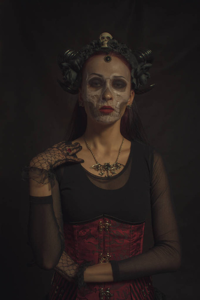 Horned gothic lady posing over dark background - Photo, image