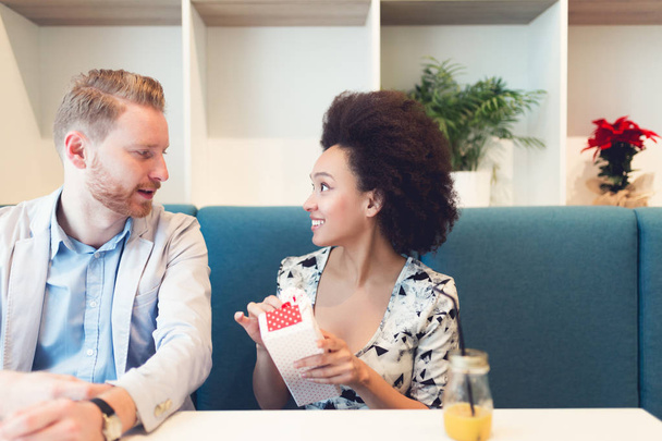 multiethnische Paarbeziehungen. schöner rothaariger Mann mit schöner afroamerikanischer Frau beim Urlaub im Café - Foto, Bild