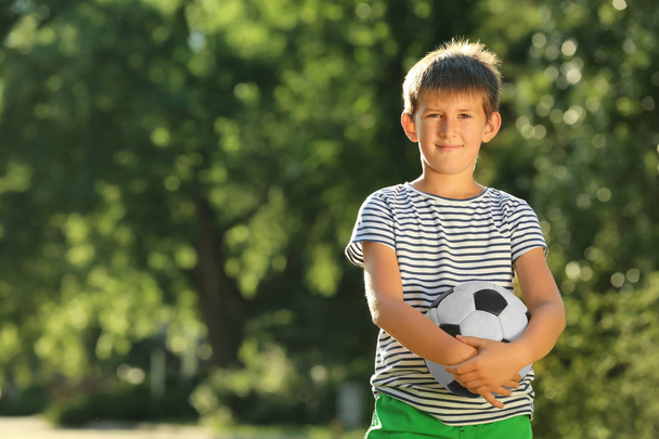 Cute boy with soccer ball in park - Φωτογραφία, εικόνα