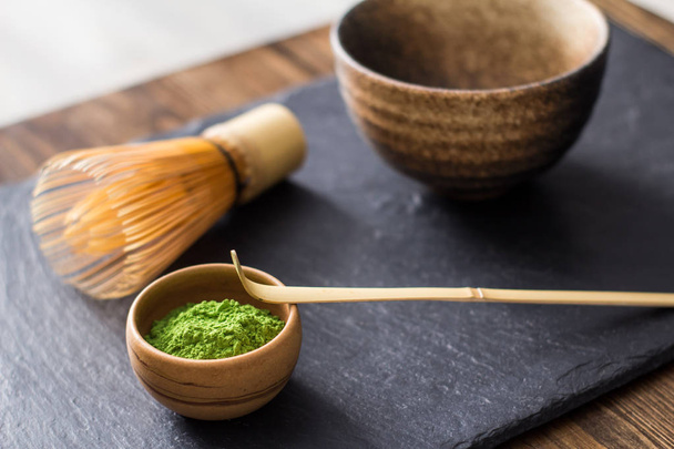 green matcha tea prepearing on stone black table - Zdjęcie, obraz