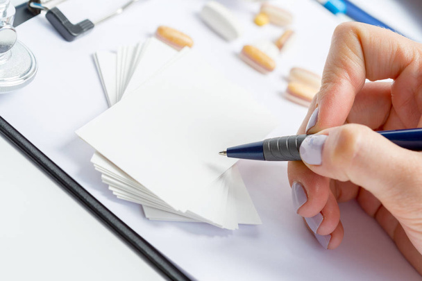 hand of doctor writing prescription on paper sheet - Фото, зображення
