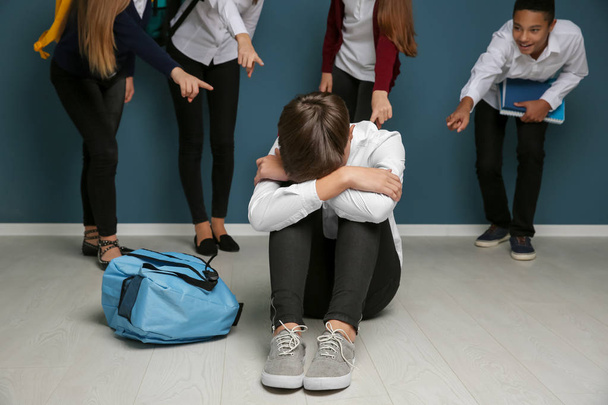Teens bullying their classmate indoors - Foto, Imagem