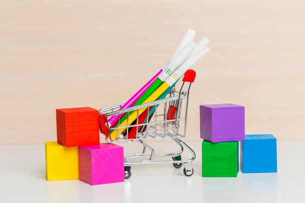Stationery items in shopping trolley, close-up  - Foto, Bild
