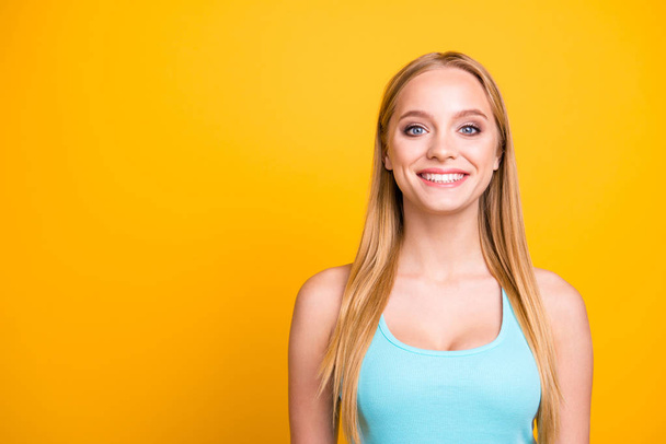 Portrait of young beautiful blond girl, isolated on yellow background with copy space for text. Cute female model with big smile looking at camera - Foto, immagini