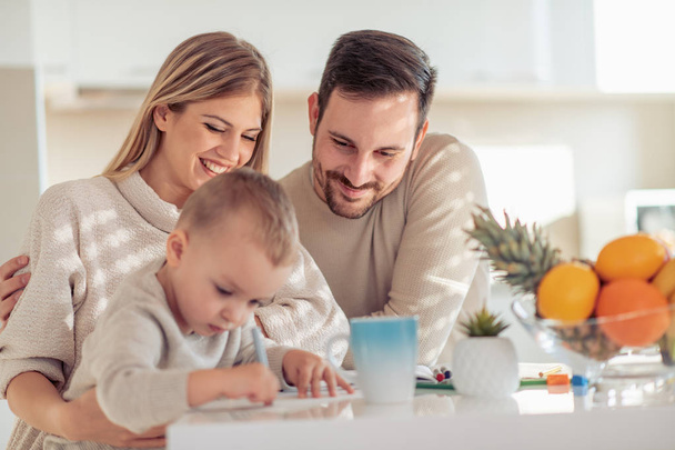 Young family with child drawing at home.  - Photo, Image