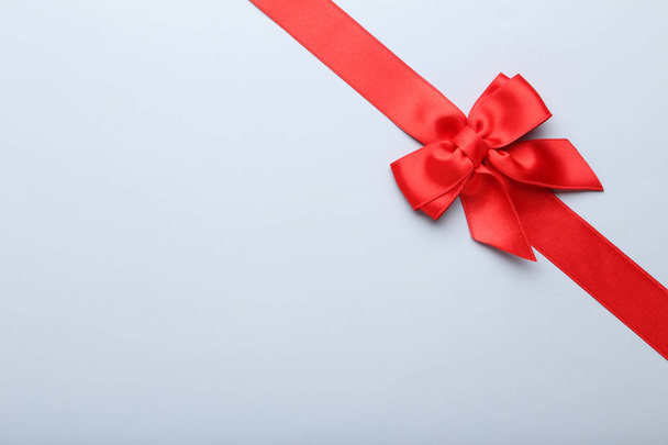Red bow with ribbon on grey background - Zdjęcie, obraz
