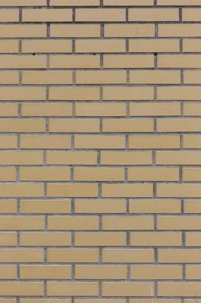gelb mit grauen Nähten Stein Ziegel Wandmuster Textur Hintergrund vertikale Aufnahme - Foto, Bild