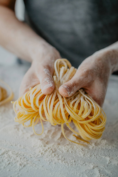 Closeup of process of making cooking homemade pasta. Chef make fresh italian traditional pasta  - 写真・画像